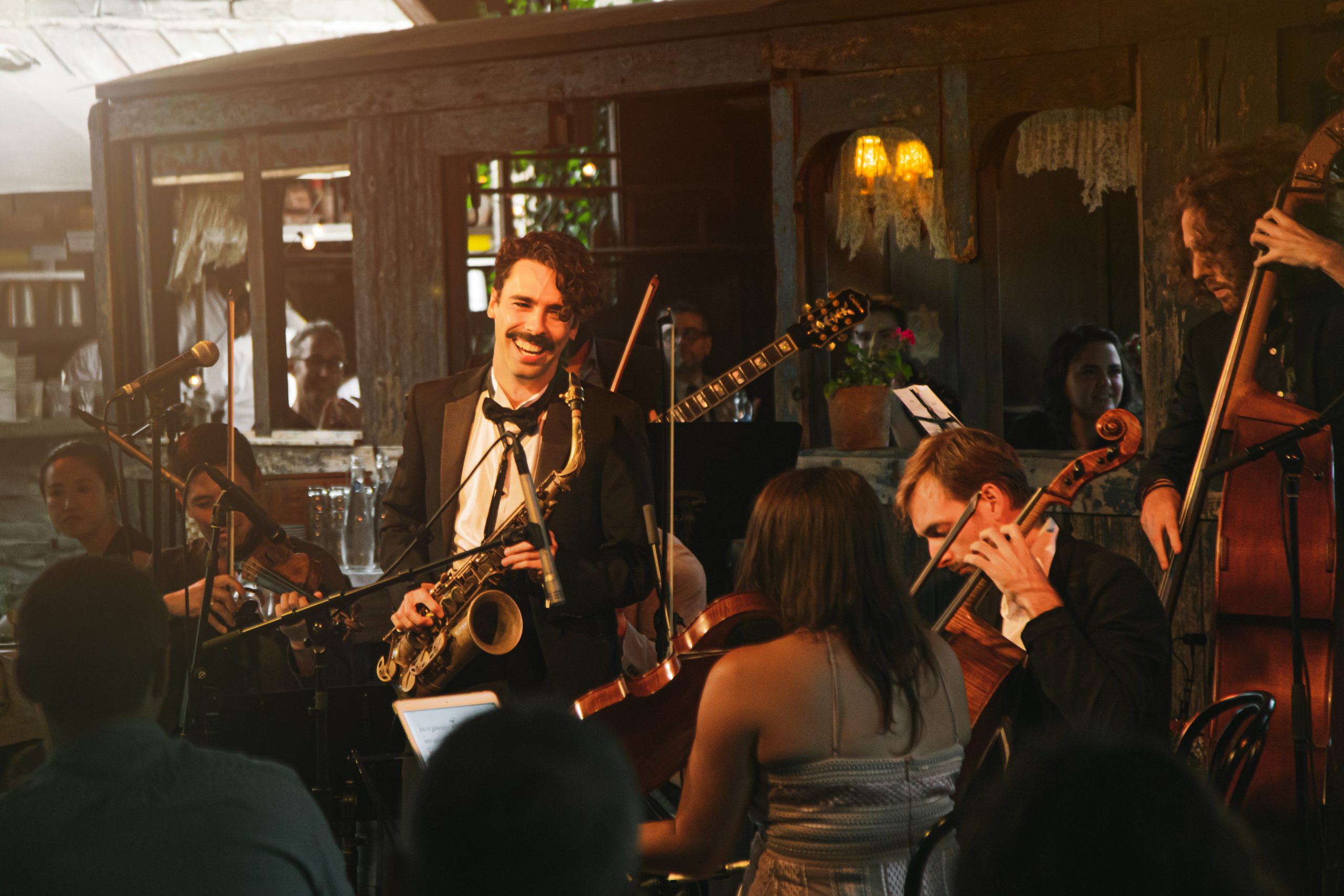 Saxophonist Eddie Barbash playing music with a string quartet.